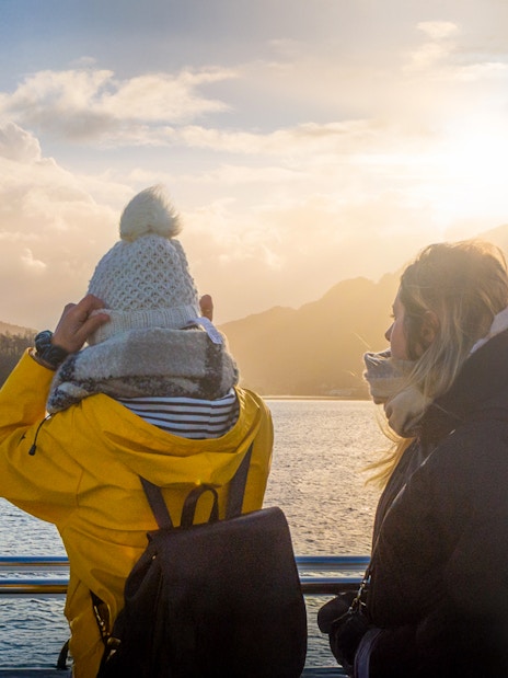 People enjoying scenic views on deck during Mostraumen Fjord Cruise.