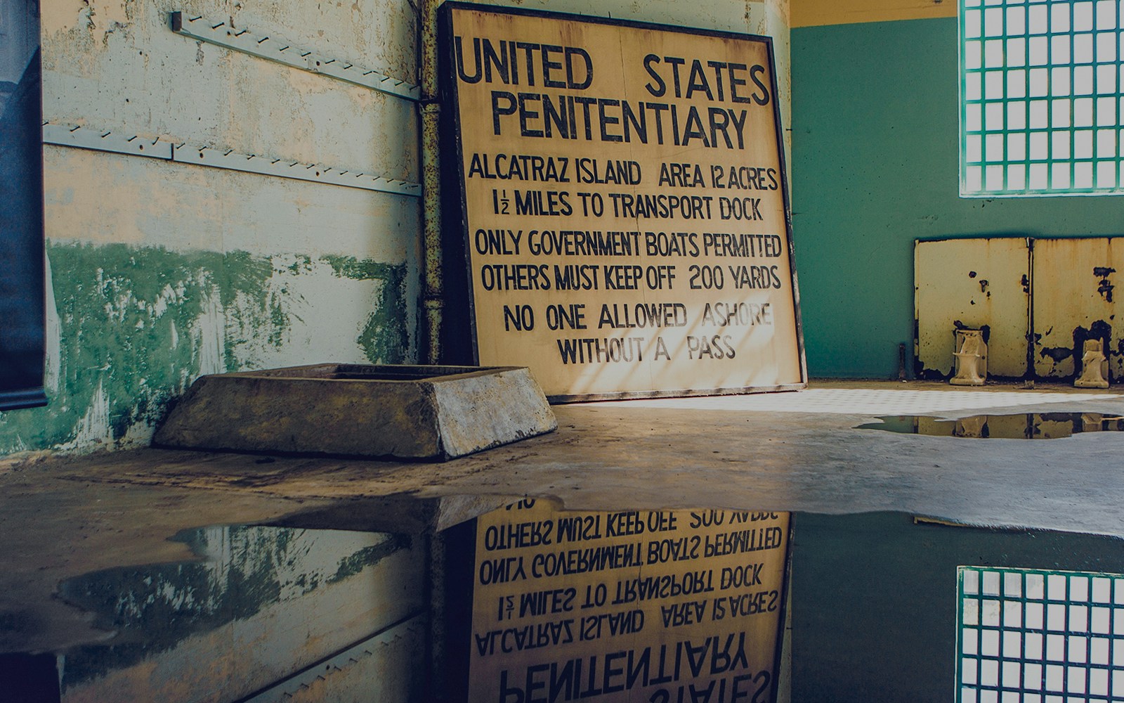 Alcatraz prison signage in San Francisco, California, highlighting historical tour details.