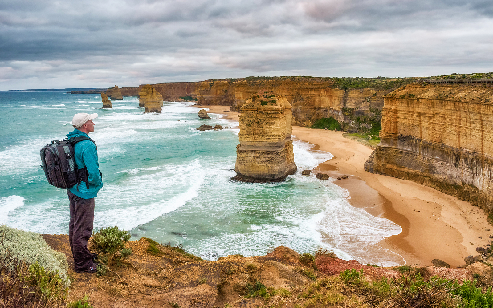 Great Ocean Walk trail with tourists hiking along coastal cliffs in Victoria, Australia.