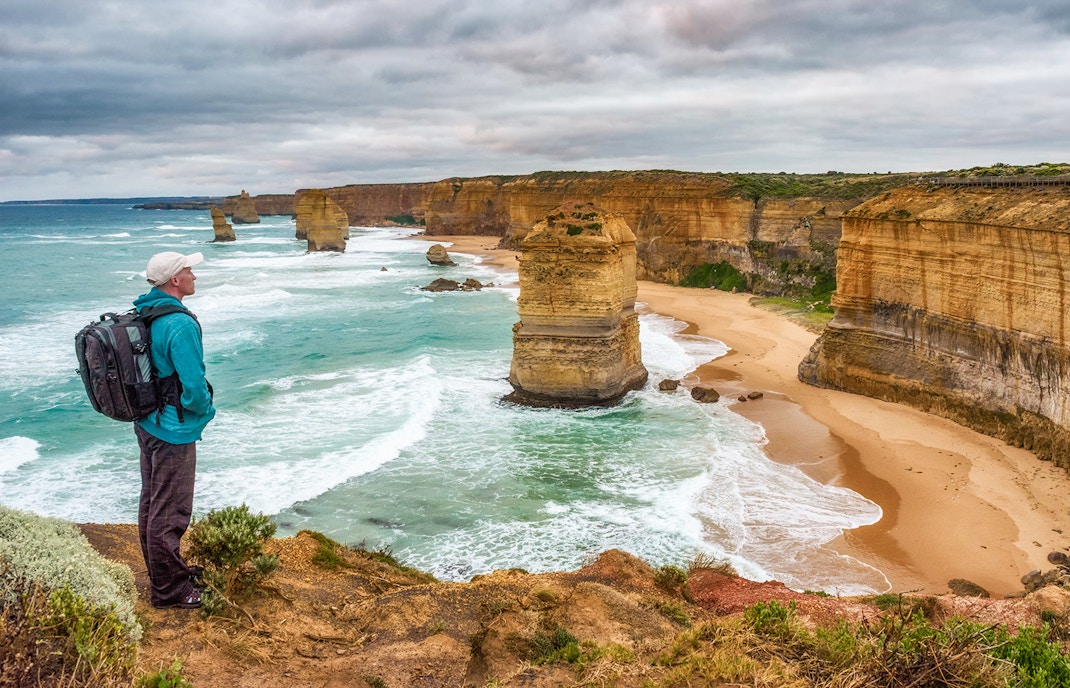 Great Ocean Walk trail with tourists hiking along coastal cliffs in Victoria, Australia.