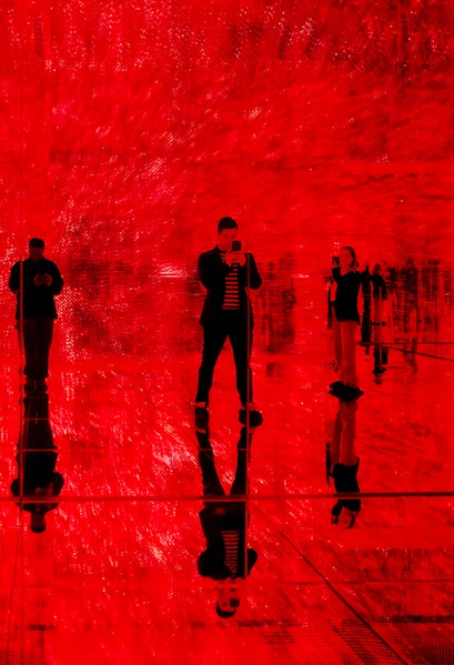 Visitors in a red-lit room at Mercer Labs: Museum Of Art & Technology exhibit.