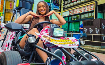 Go-karting in Dotonbori, Osaka with Monkey Kart, vibrant street backdrop.