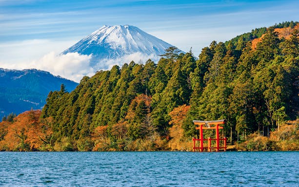 Red Torii gate with Mt. Fuji in the background on Hakone tour.