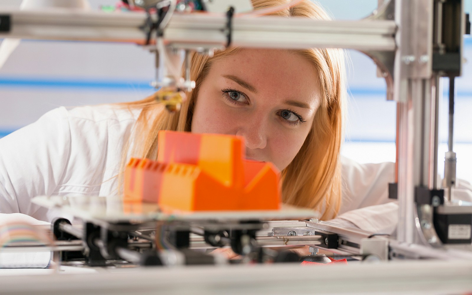 A woman looking t the block created from the 3D Scanner and Printer at the Grand Egyptian Museum