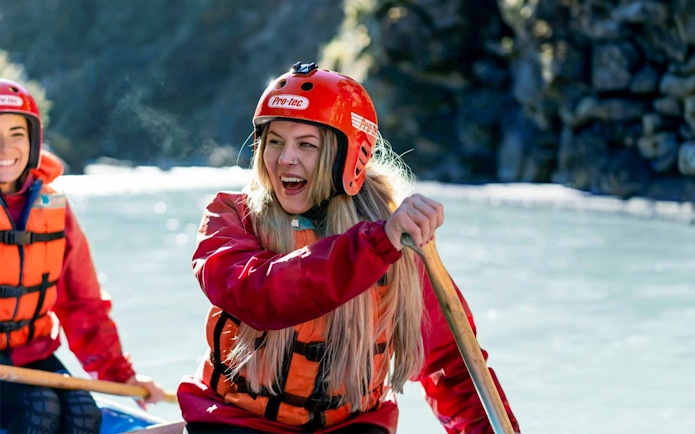 Whitewater rafting on Shotover River, Queenstown, with participants paddling.