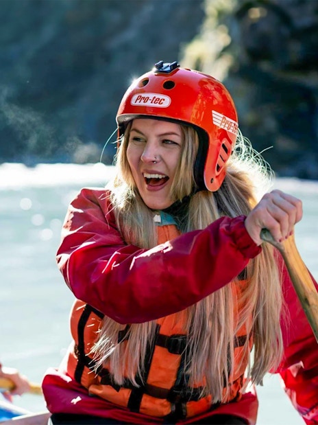 Whitewater rafting on Shotover River, Queenstown, with participants paddling.