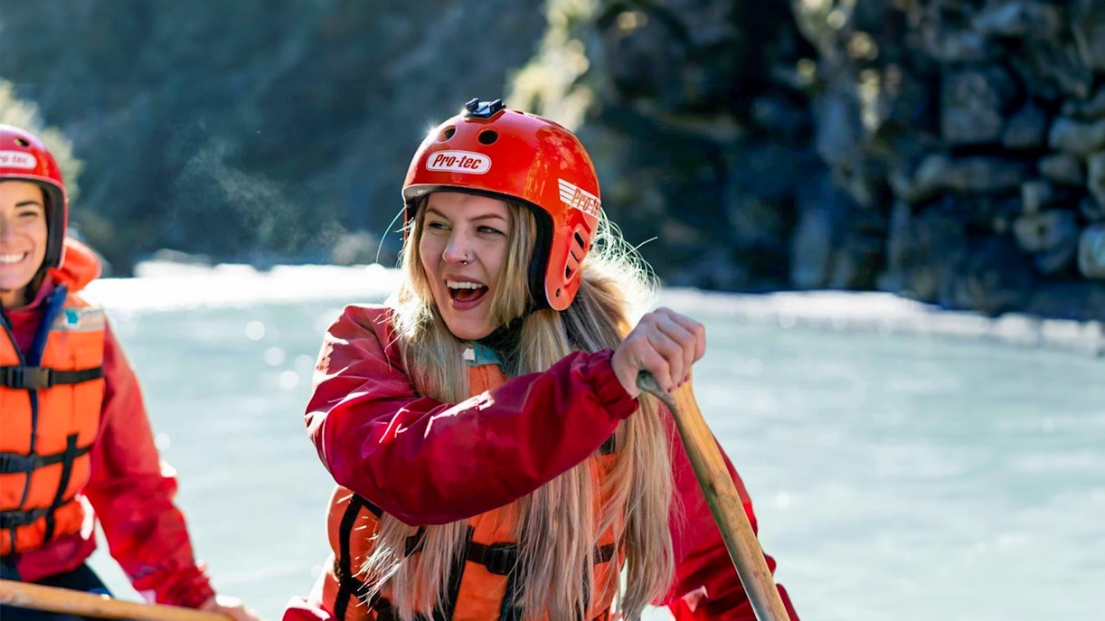 Whitewater rafting on Shotover River, Queenstown, with participants paddling.
