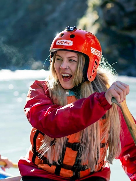 Whitewater rafting on Shotover River, Queenstown, with participants paddling.