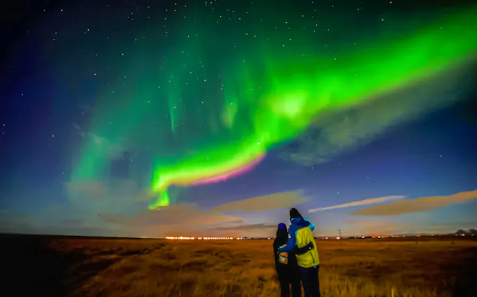 Guests viewing northern lights on a small-group tour from Reykjavik.