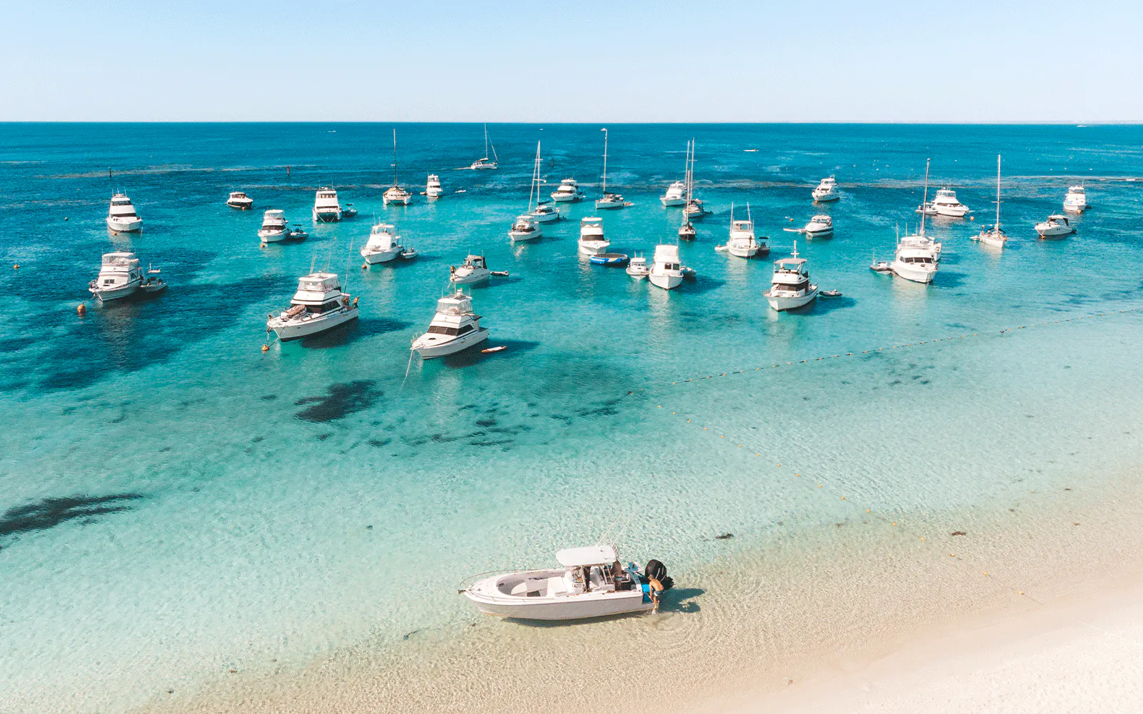Boats anchored in clear waters off Rottnest Island, Perth, Western Australia.