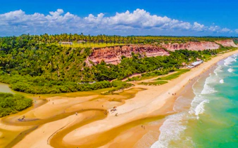 Aerial view of Arraial d'Ajuda beach with cliffs and ocean, Porto Seguro, Brazil.