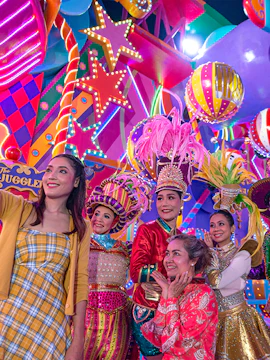 Performers in colorful costumes at Carnival Magic Park Phuket.