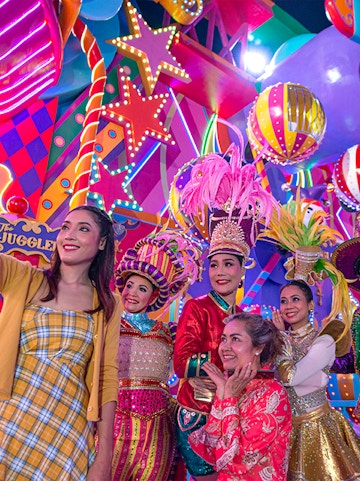 Performers in colorful costumes at Carnival Magic Park Phuket.