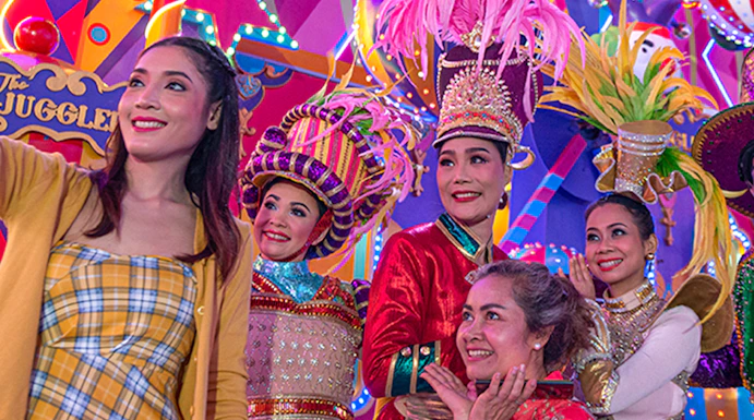 Performers in colorful costumes at Carnival Magic Park Phuket.