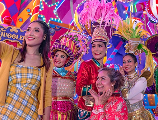 Performers in colorful costumes at Carnival Magic Park Phuket.
