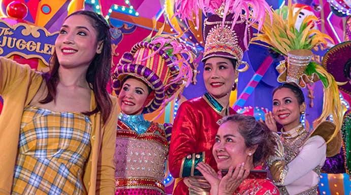 Performers in colorful costumes at Carnival Magic Park Phuket.