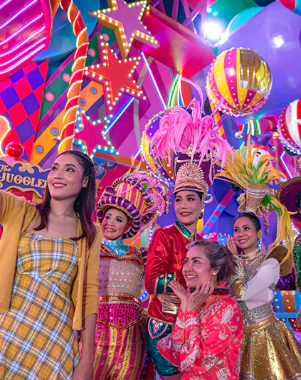 Performers in colorful costumes at Carnival Magic Park Phuket.