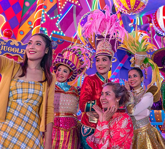 Performers in colorful costumes at Carnival Magic Park Phuket.
