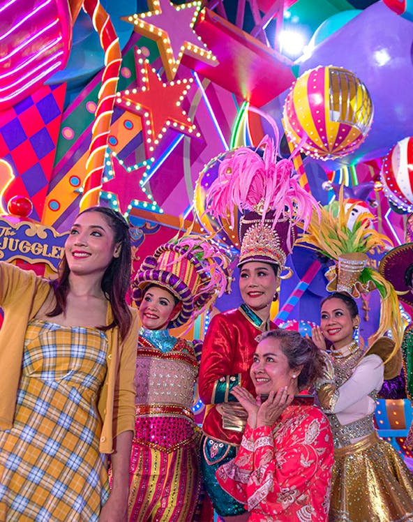 Performers in colorful costumes at Carnival Magic Park Phuket.