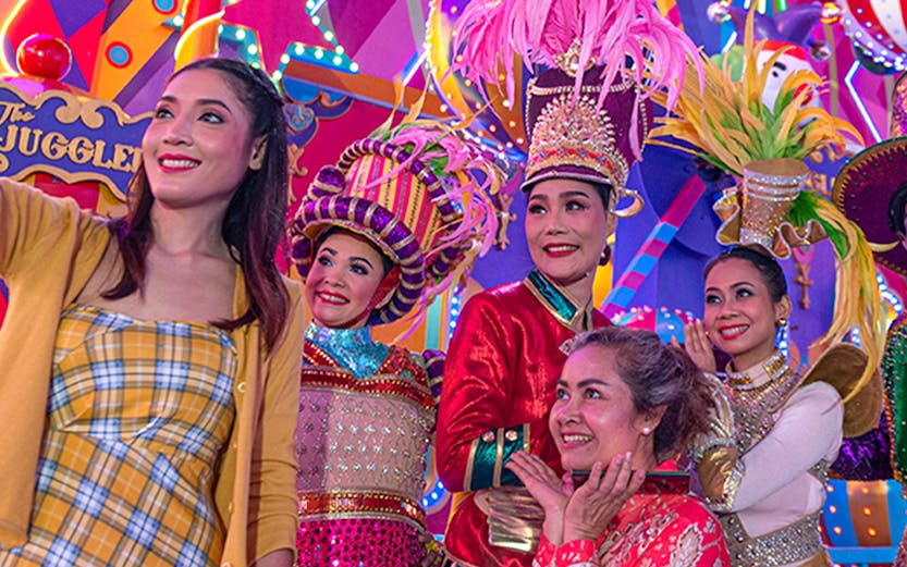 Performers in colorful costumes at Carnival Magic Park Phuket.