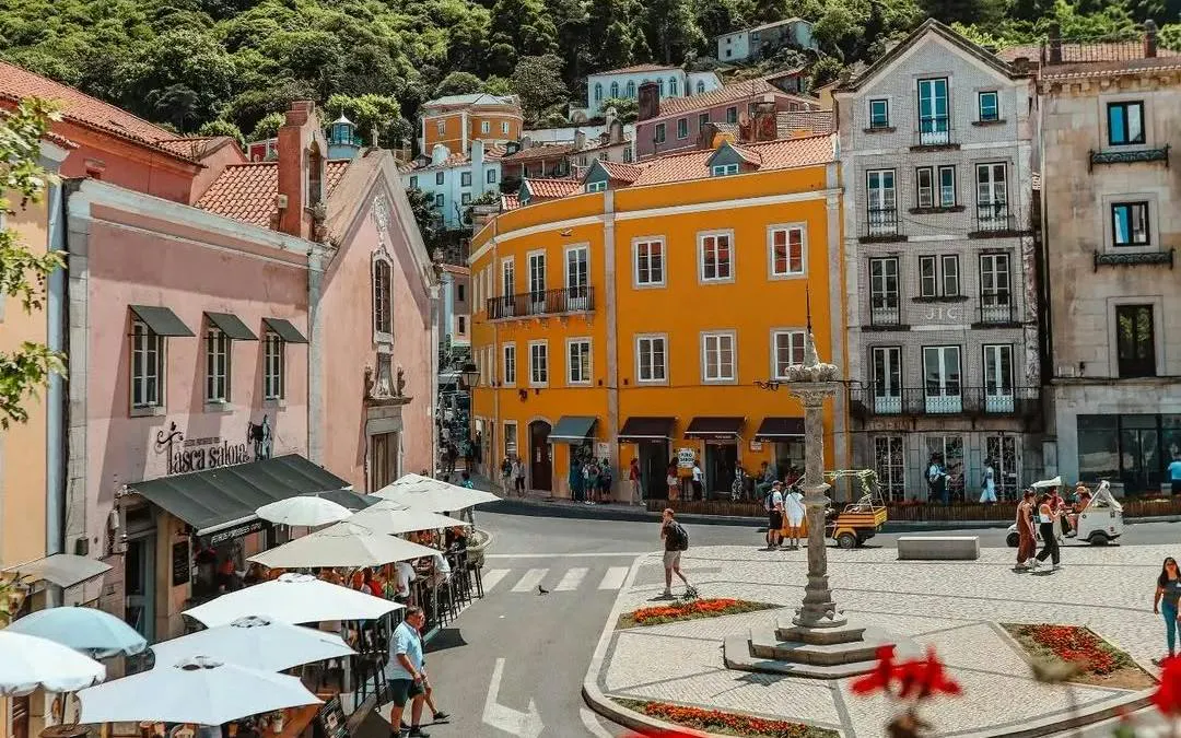 Colorful buildings and outdoor cafes in Sintra town square, Portugal.
