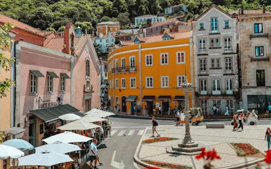 Colorful buildings and outdoor cafes in Sintra town square, Portugal.