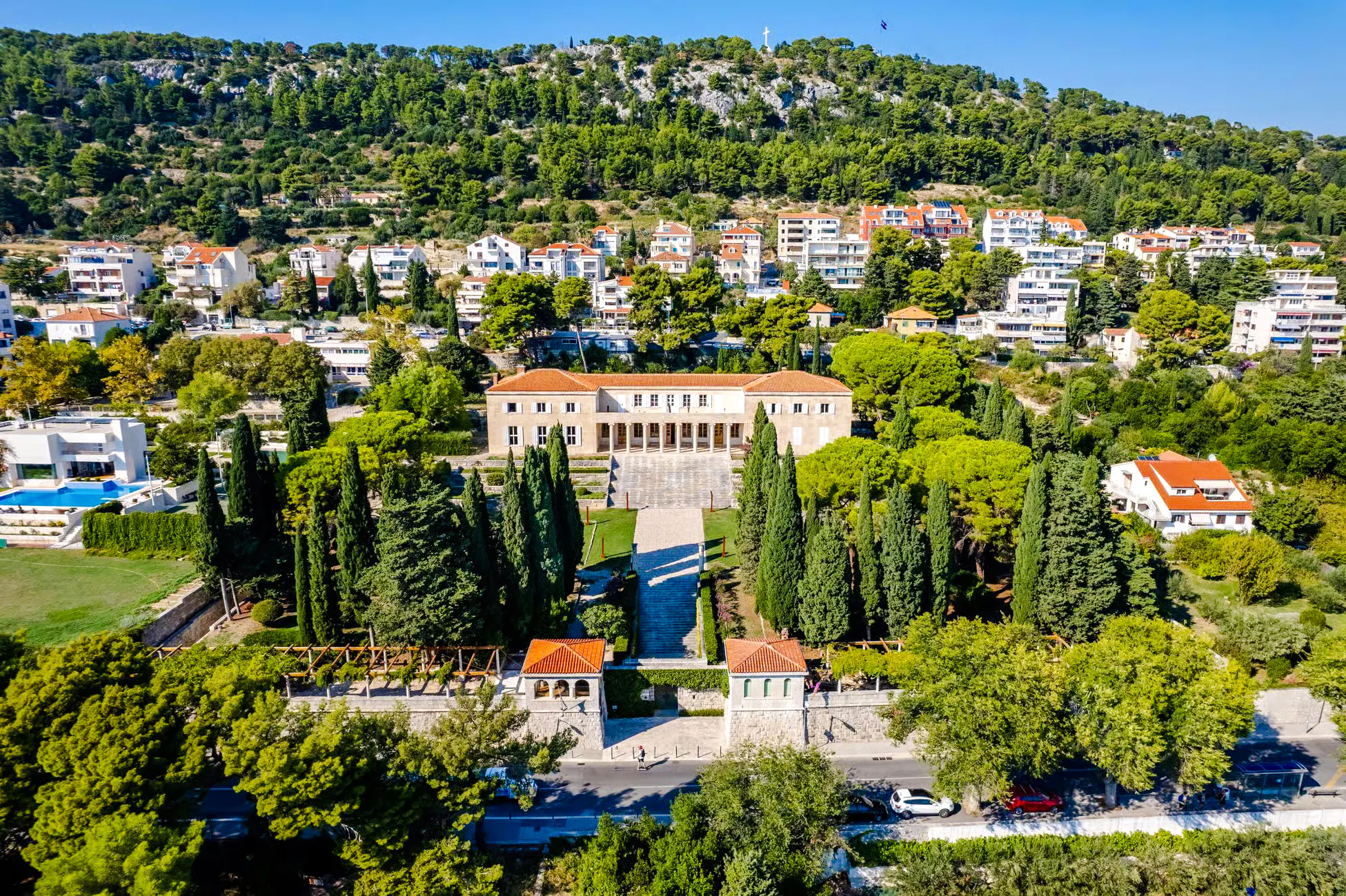 Aerial view of Split with historic architecture and lush greenery, highlighting Diocletian's Palace area.