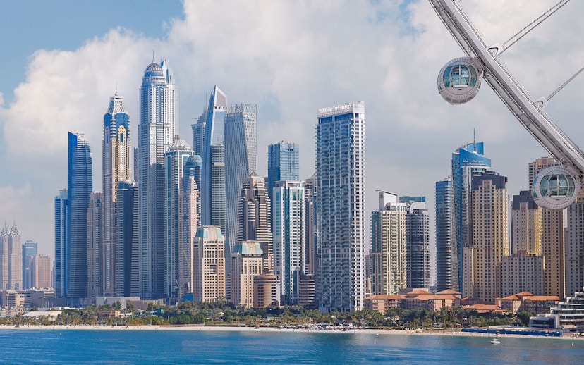 Ain Dubai pods overlooking Dubai Marina skyline.