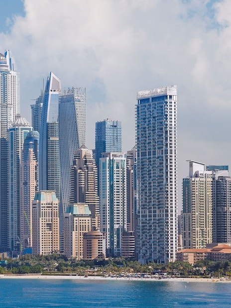 Ain Dubai pods overlooking Dubai Marina skyline.