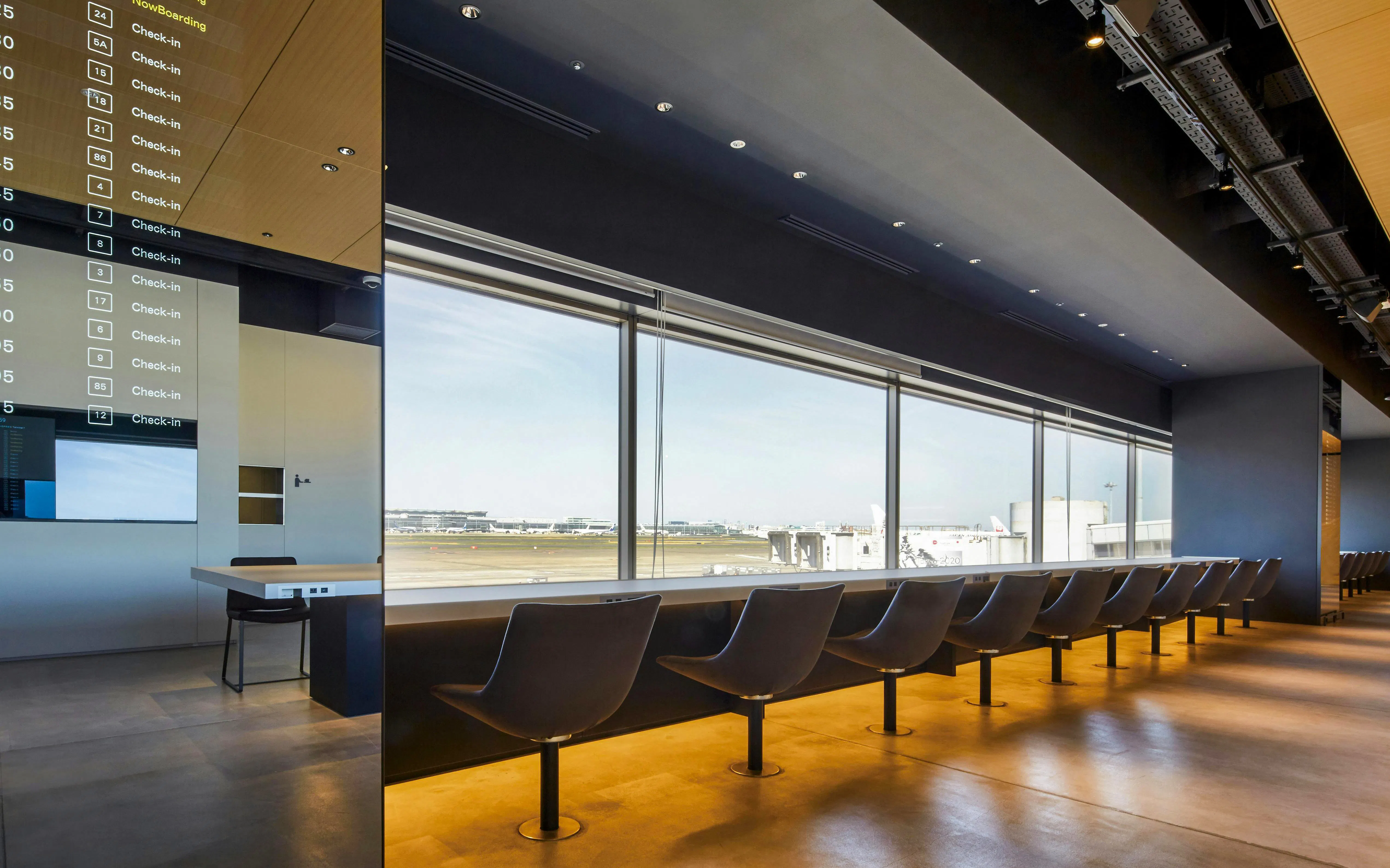 Seating area with runway view at POWER LOUNGE SOUTH, Tokyo International Airport.