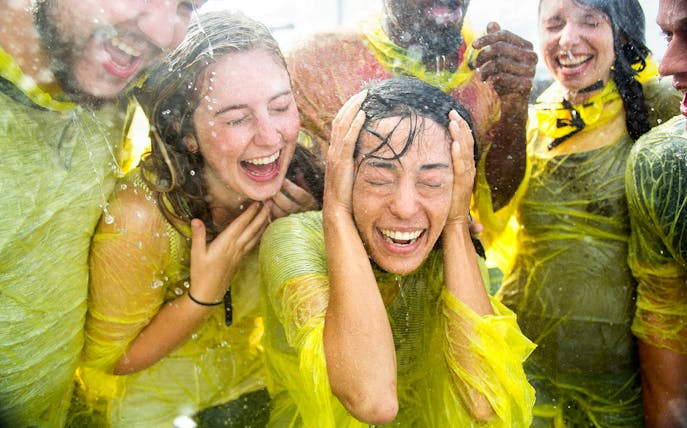 Visitors enjoying the spray on the Maid of the Mist boat tour at Niagara Falls USA.