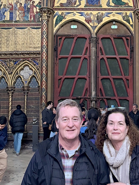 Visitors inside Sainte Chapelle, Paris, admiring the ornate interior and stained glass.