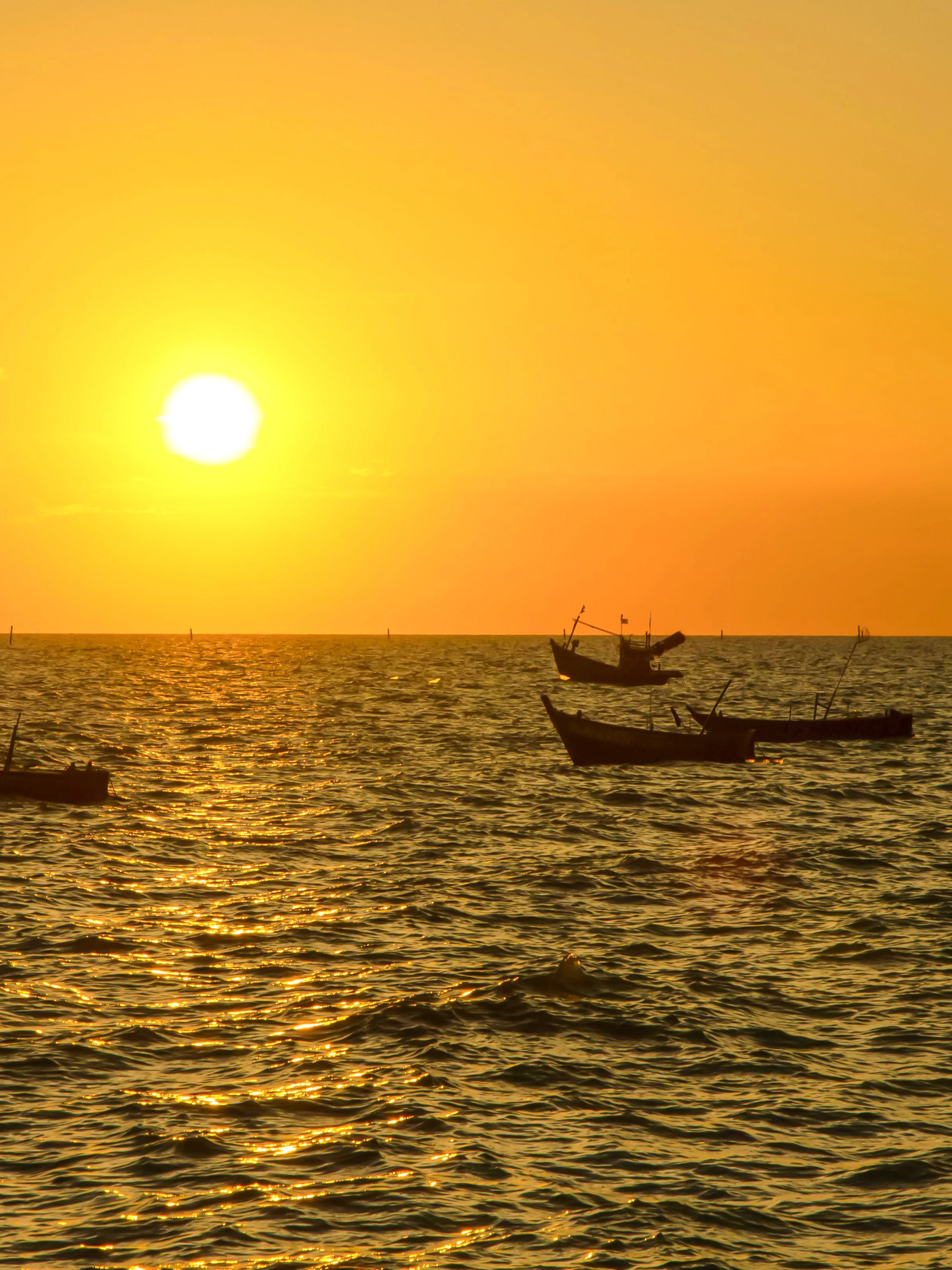 Boats floating on the sea at sunrise in Nice.
