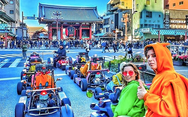 Go-kart riders in colorful costumes near Tokyo's Senso-ji Temple during Skytree tour.