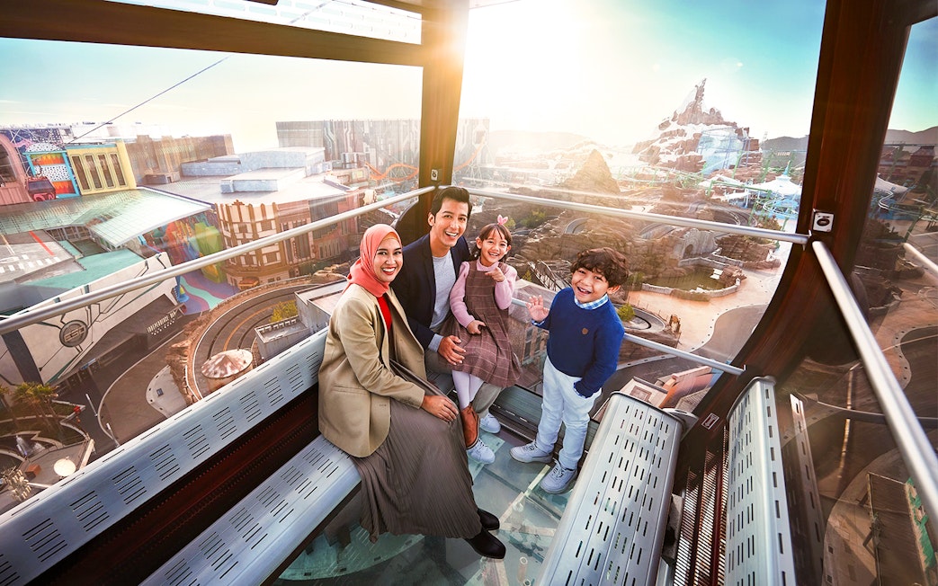 Family enjoying view inside Genting Awana SkyWay Cable Car, Malaysia.