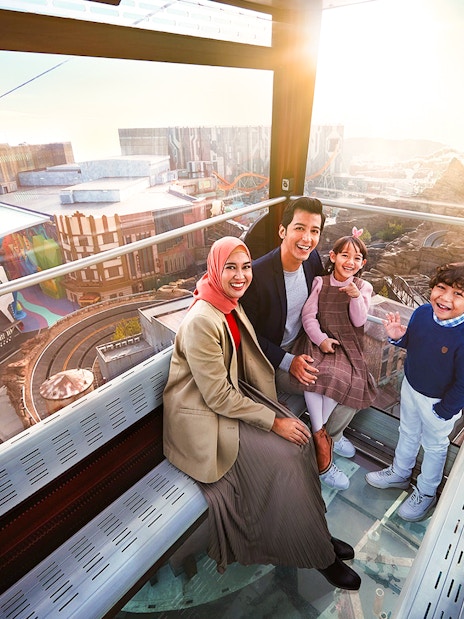 Family enjoying view inside Genting Awana SkyWay Cable Car, Malaysia.