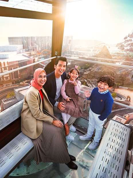 Family enjoying view inside Genting Awana SkyWay Cable Car, Malaysia.