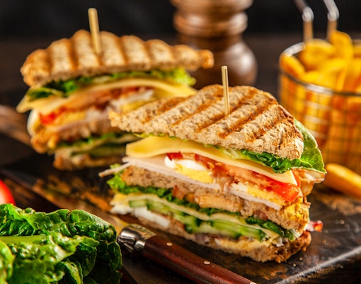 Dining area at Tibidabo Park with tables set among lush greenery.