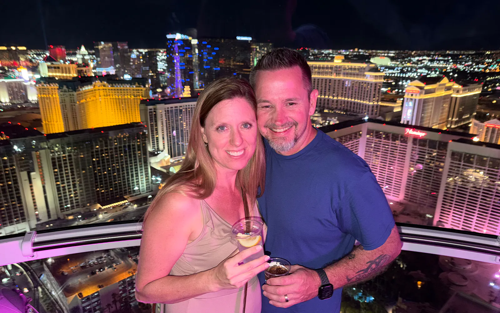 Guests enjoying the view from the High Roller gondola in Las Vegas at night.