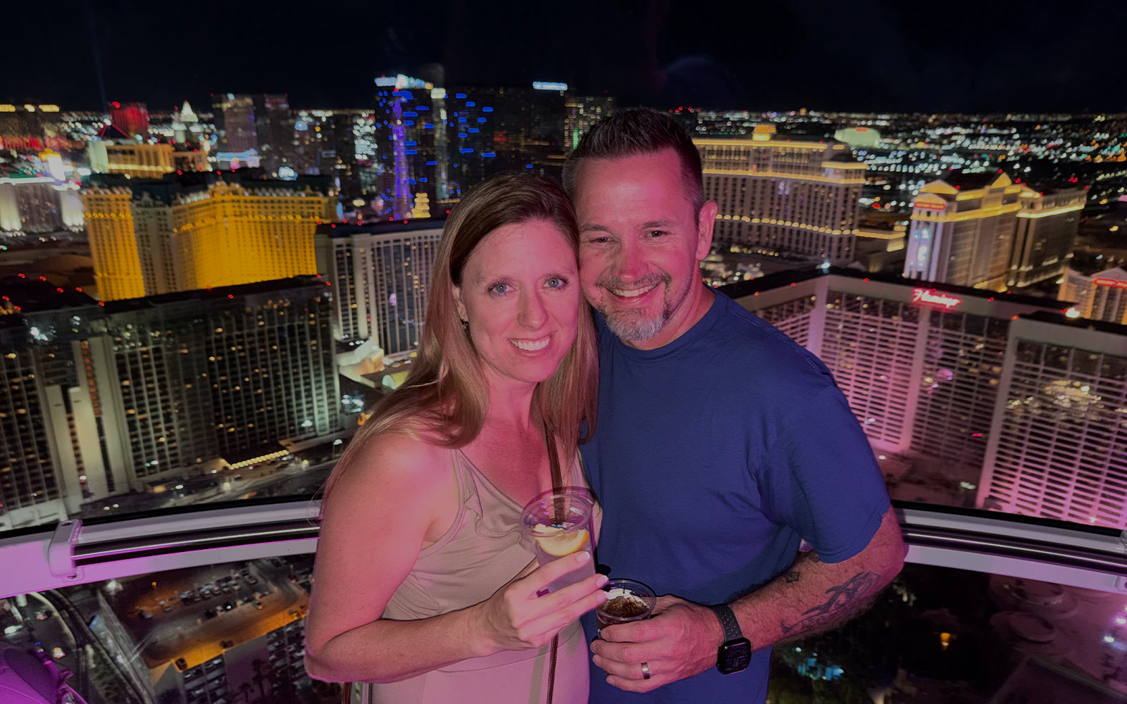 Guests enjoying the view from the High Roller gondola in Las Vegas at night.