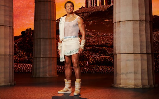 Man in ancient Greek attire stands between columns, representing Disney's Hercules.