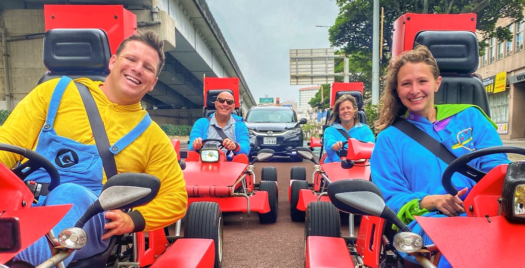 Street go-karting group in colorful costumes driving through Okinawa.