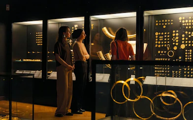 Visitors viewing gold artifacts at the National Museum of Denmark exhibit.