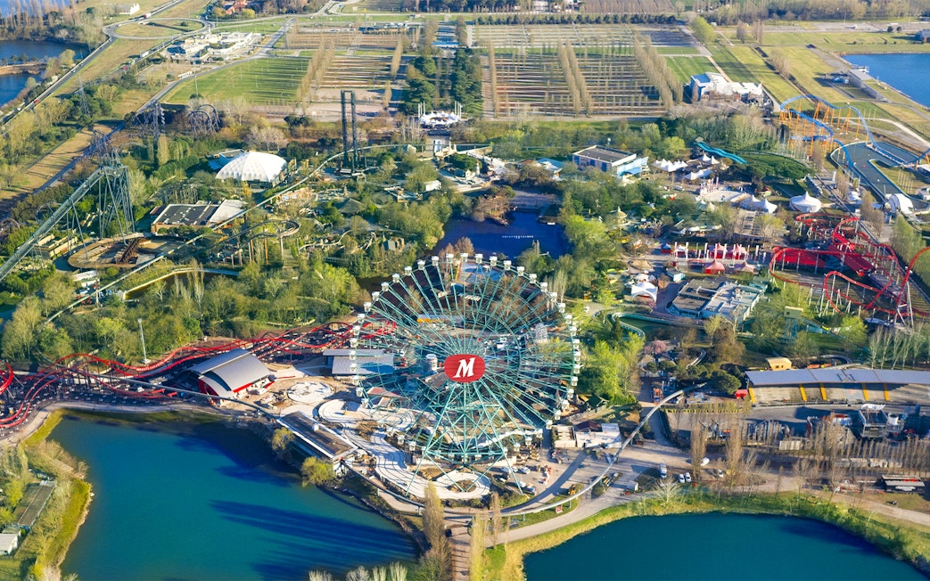 Aerial view of Mirabilandia Park with Ferris wheel and roller coasters, Italy.