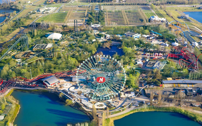 Aerial view of Mirabilandia Park with Ferris wheel and roller coasters, Italy.
