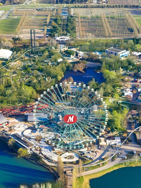 Aerial view of Mirabilandia Park with Ferris wheel and roller coasters, Italy.