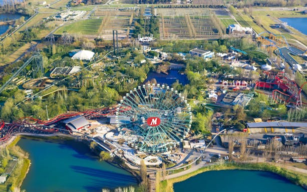 Aerial view of Mirabilandia Park with Ferris wheel and roller coasters, Italy.