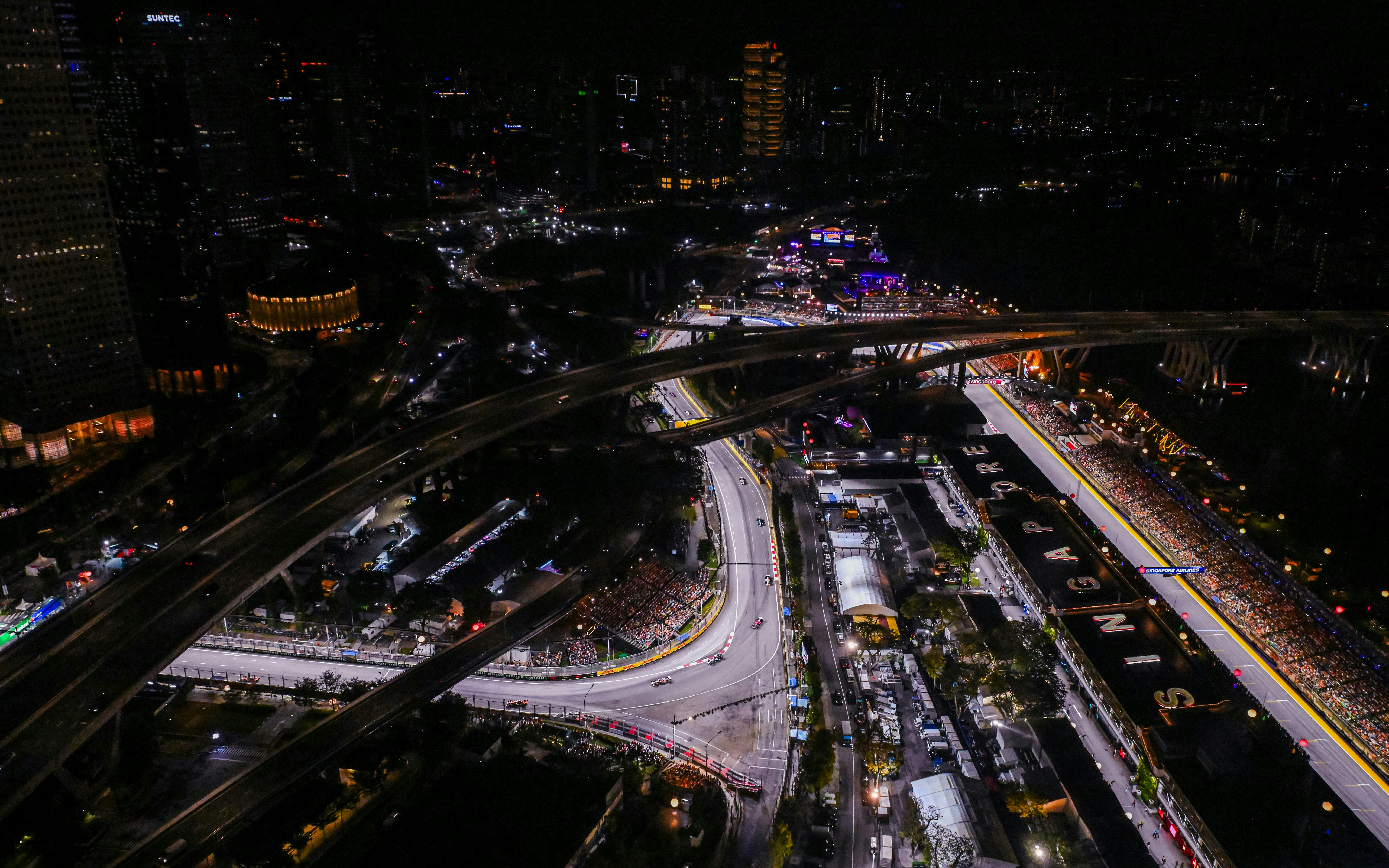 Aerial view of the illuminated Formula 1 Singapore Grand Prix circuit at night.