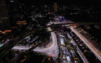 Aerial view of the illuminated Formula 1 Singapore Grand Prix circuit at night.