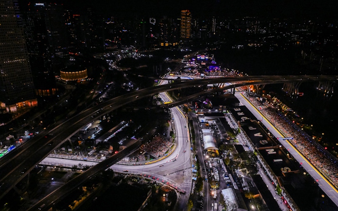 Aerial view of the illuminated Formula 1 Singapore Grand Prix circuit at night.